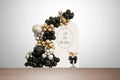 A Tini Bit Older adult milestone birthday decoration kit in black, gold, and cream with martini cutouts